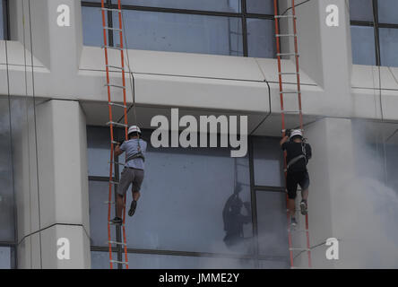 Haikou, China's Hainan Province. 28th July, 2017. People attend a high-rise building fire drill in Haikou, capital of south China's Hainan Province, July 28, 2017. Credit: Yang Guanyu/Xinhua/Alamy Live News Stock Photo