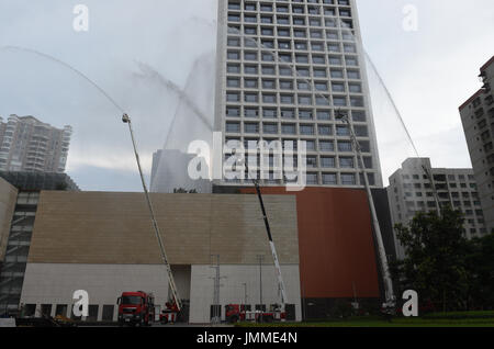 Haikou, China's Hainan Province. 28th July, 2017. Fire engines are used during a high-rise building fire drill in Haikou, capital of south China's Hainan Province, July 28, 2017. Credit: Yang Guanyu/Xinhua/Alamy Live News Stock Photo