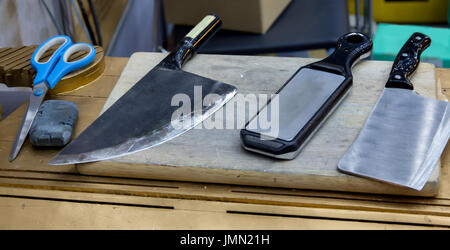 Sharpening knife on grinder grinding on bench grinder using making sharp  for easy cutting UK England GB (release available Stock Photo - Alamy