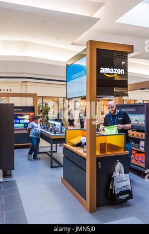 Fairfax, USA - February 18, 2017: Amazon storen inside in mall with technology items for sale and clerk Stock Photo