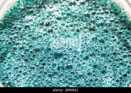 Abstract background of green emerald bubbles on surface of spirulina smoothie drink Stock Photo