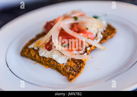 Macro closeup of healthy onion appetizer on chia flatbread toast and cheese Stock Photo