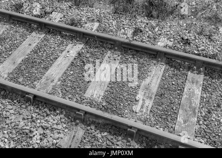 Monochrome image of a small section of railway / railroad track - metaphor for 'end of the line', rail transport, and general concept of freight. Stock Photo
