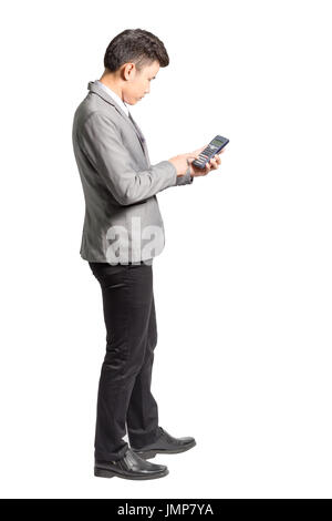 Portrait of a young business man using calculator. Isolated full body on white background Stock Photo