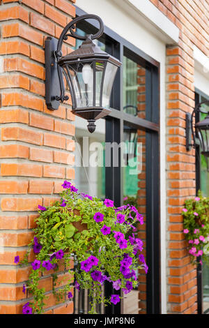 Building decorated with outdoor lamp and flowers Stock Photo