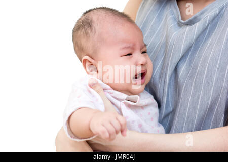 Portrait of an asian mother holding her crying cute little baby. Isolated on white background Stock Photo