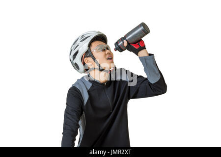 Portrait of a young asian man cyclist with helmet and sportswear drinking water on his bicycle. Isolated on white background with clipping path Stock Photo