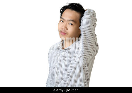 Portrait of a young asian business man making (the hair) smooth and glossy, typically by applying pressure or moisture to it. Isolated on white backgr Stock Photo