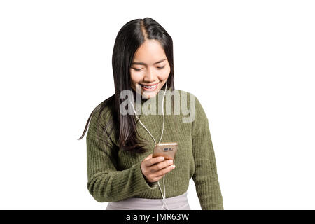 Portrait of a woman smiling with earbuds / headphone for listening to music on smart phone or mp3 player. Isolated on white background with copy space Stock Photo