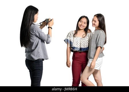 Portrait of a group of friends are taking a photo. Isolated on white background with copy space and clipping path Stock Photo