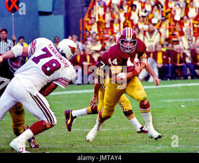 Washington Redskins running back John Riggins (44) carries the ball during  early workout after Riggins arrived at the Redskins training camp in  Carlisle, Pa., for practice, July 21, 1981. (AP Photo/Paul Vathis