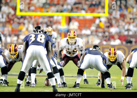 The Baltimore Ravens' Demetrius Williams (87) is brought down by the Washington  Redskins' Rocky McIntosh (52) and London Fletdcher (59) in the first half  of their preseason game in Landover, Maryland, on