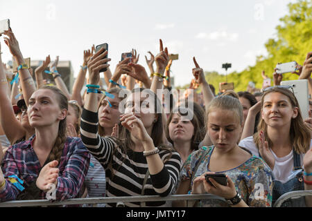 KIEV, UKRAINE - JUNE 29, 2017: Young fans enjoy music concert at the Atlas Weekend music festival in National Expocenter. Stock Photo