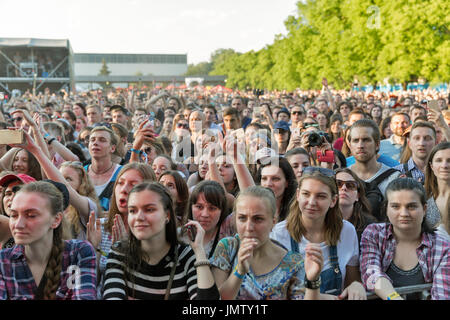 KIEV, UKRAINE - JUNE 29, 2017: Young fans enjoy music concert outdoors at the Atlas Weekend music festival in National Expocenter. Stock Photo