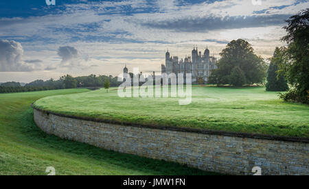 The majestic Burghley House near Stamford Lincolnshire taken during sunrise on cool autumn day Stock Photo