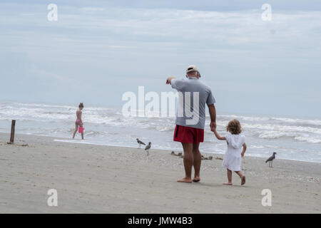 Grandpa and granddaughter on the beach Stock Photo