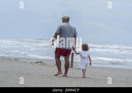 Grandpa and granddaughter on the beach Stock Photo