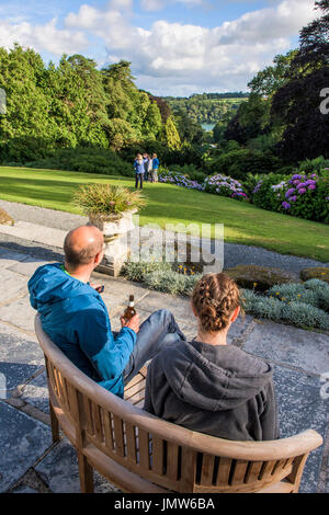 People relaxing and enjoying the view overlooking the sub-tropical Trebah Garden in Cornwall. Stock Photo
