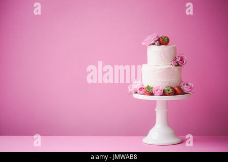 Cake decorated with fresh fruit and flowers Stock Photo
