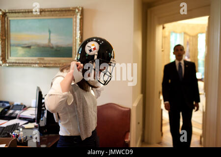 Washington, DC - May 28, 2009 -- United States President Barack Obama's personal secretary, Katie Johnson, tries on a Pittsburgh Steelers football helmet outside the Oval Office, May 21, 2009.   .Mandatory Credit: Pete Souza - White House via CNP