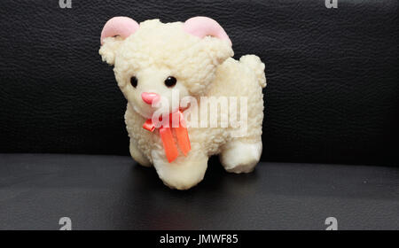 Soft baby toy white sheep isolated on black background. Stock Photo