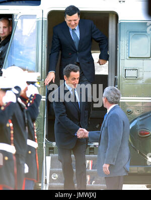Camp David, MD - October 18, 2008 --  United States President George W. Bush, right, welcomes President Nicolas Sarkozy of France, who also serves as this year's rotating President of the European Union (EU), left, and President JosÃ Manuel Barroso of the European Commission (EC), top, to the Presidential Retreat near Thurmont, Maryland for talks on Saturday, October 18, 2008.  The two European leaders stopped at Camp David to meet with President Bush to discuss the economy on their way home from a summit in Canada to try to convince Bush to support a summit by year's end to try to reform the 
