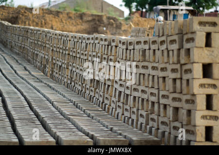 AMRITSAR, PUNJAB, INDIA - 21 APRIL 2017 : bricks lined up to dry at a brick manufacturing facility in India Stock Photo