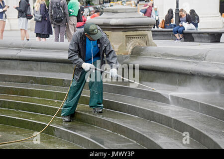 A new York City Parks Department worker power washing the area around the fountain in Washington Square Park in Greenwich Village, New York City. Stock Photo