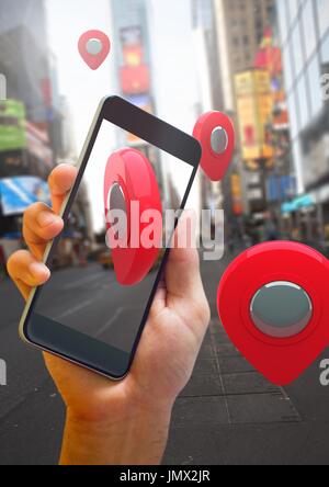 Digital composite of Holding phone and Location pointer markers in city street Stock Photo