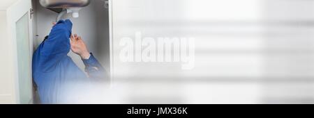 Digital composite of Plumber man repairing pipes Stock Photo