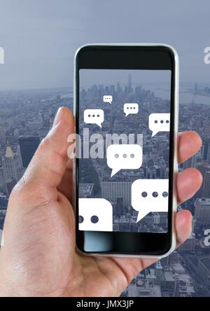 Digital composite of Holding phone and Chat bubble icons over city Stock Photo