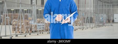 Digital composite of Mechanic man holding a pen and a folder Stock Photo