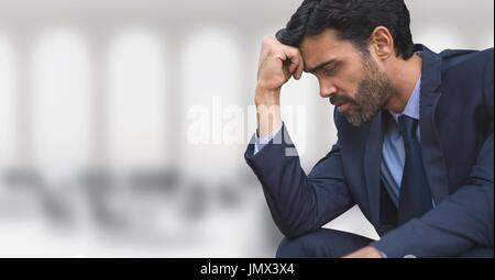 Digital composite of Worried business man sitting against office background Stock Photo