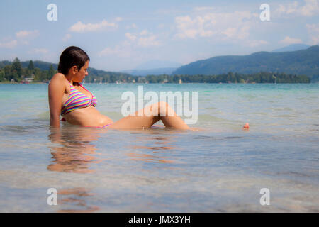 A women enjoying a sunny day at Wörthersee in Austria Stock Photo