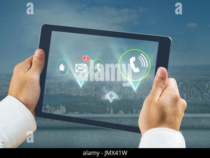 Digital composite of Holding tablet and Various app icons illuminated over city Stock Photo