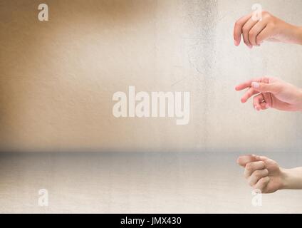 Digital composite of Three hands with rustic background Stock Photo