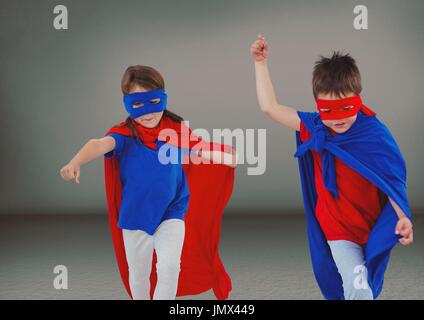 Digital composite of Superhero kids with blank grey background Stock Photo