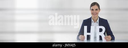 Digital composite of Woman standing behind a table with HR text as company insurance concept Stock Photo