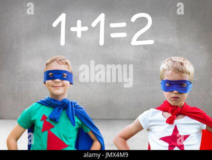 Digital composite of Superhero kids with blank grey background with 1 + 1 = 2 text Stock Photo