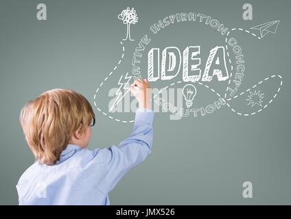 Digital composite of Boy writing in front of grey blank background with idea graphics Stock Photo