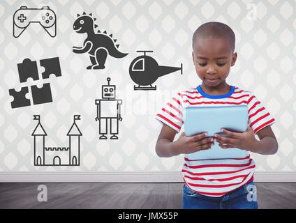 Digital composite of Boy holding tablet in blank room with toys graphics Stock Photo