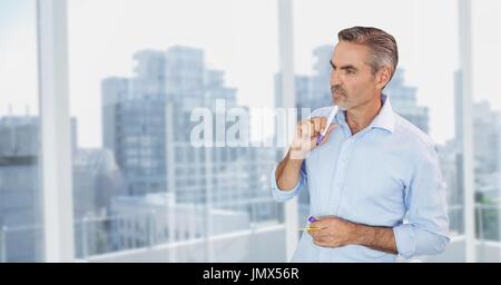 Digital composite of Business man thinking against city background Stock Photo