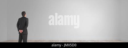 Digital composite of Business man looking at a wide blank Stock Photo