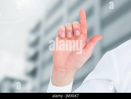 Digital composite of Hand pointing up in front of buildings Stock Photo