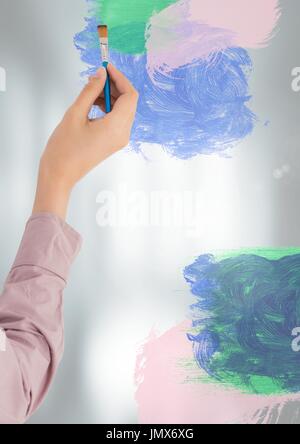 Digital composite of Hand painting on blurred glass wall Stock Photo