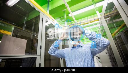 Digital composite of Digitally generated image of various icons with businessman using binoculars in office Stock Photo