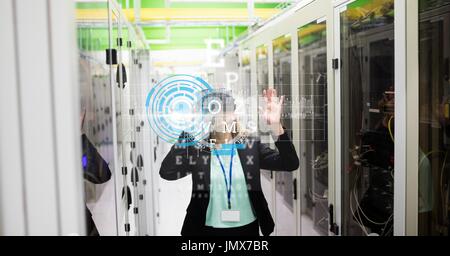 Digital composite of Businesswoman wearing VR glasses with virtual screen in foreground Stock Photo