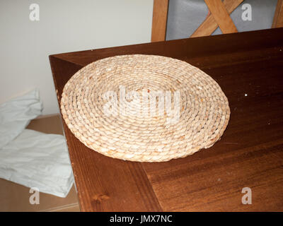 a circle spiral straw table top mat; England; UK Stock Photo