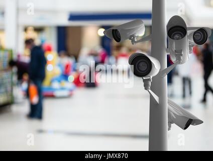 Digital composite of CCTV cameras against defocused background Stock Photo