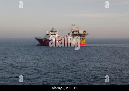 The Fugro Symphony construction vessel installing submarine export cables at the Rampion Offshore Windfarm, England. Stock Photo